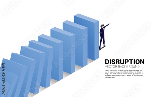 Silhouette of businessman point forward at the end of domino collapse. Concept of business industry disrupt