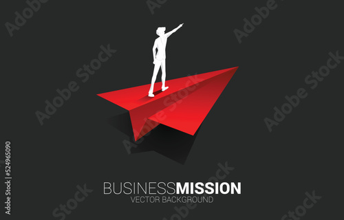 Silhouette of businessman point finger on origami paper airplane. Business Concept of leadership and vision mission.