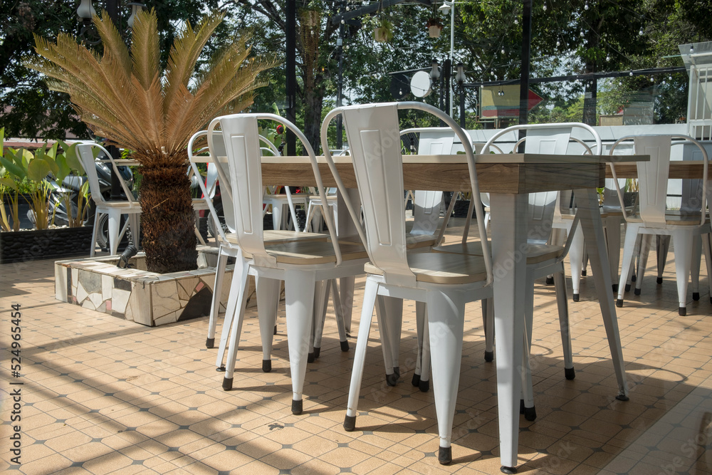 Fototapeta premium Real photo of a dining table with white chairs set on the terrace