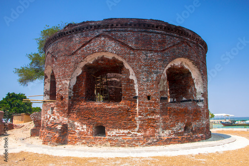 Remnants of the fortress ruins at Onrust Island, Thousand Island, Jakarta with clear blue sky background photo