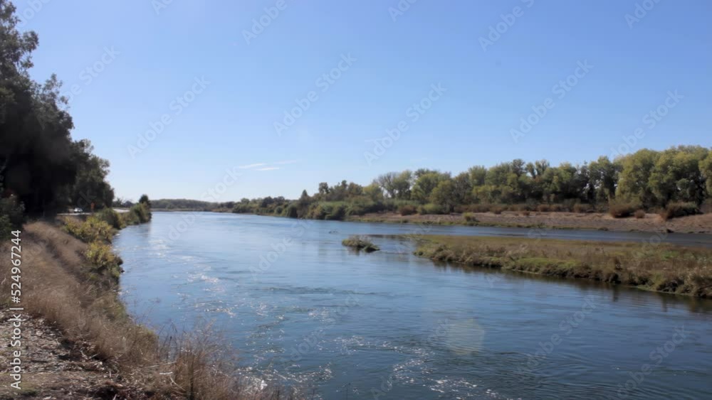 static shot of the calm Sacramento River in Butte County outside of Chico, California on a fall afternoon in 4k static shot of the calm Sacramento River in Butte County outside of Chico, California on a fall afternoon in 4k