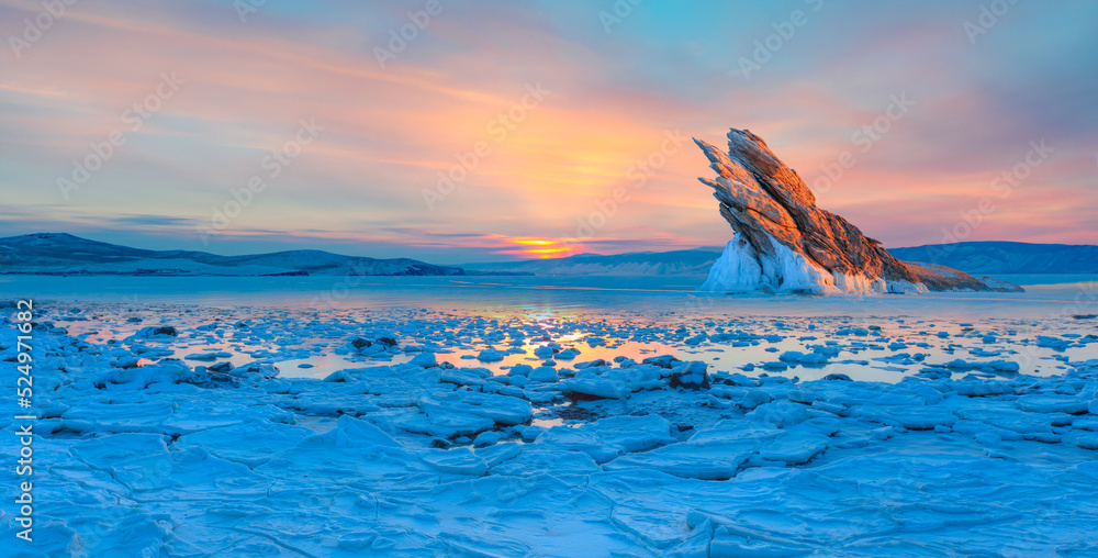 Ogoy island on winter Baikal lake with transparent cracked blue ice at sunrise - Baikal, Siberia, Russia