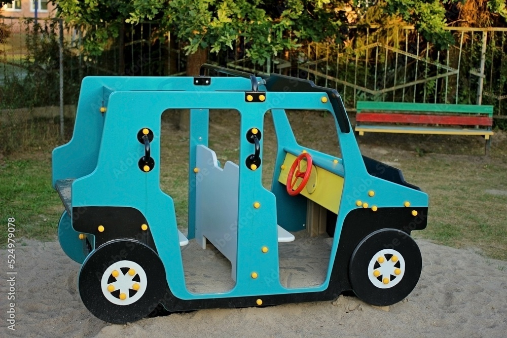 Blue painted wooden children's car in the playground