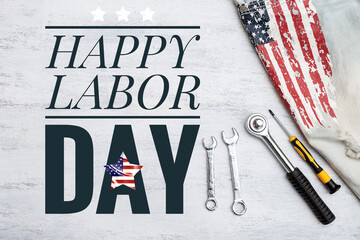 Happy Labor day sign with metal tools and jeans with USA flag print on white texture background, Labor day card concept background idea