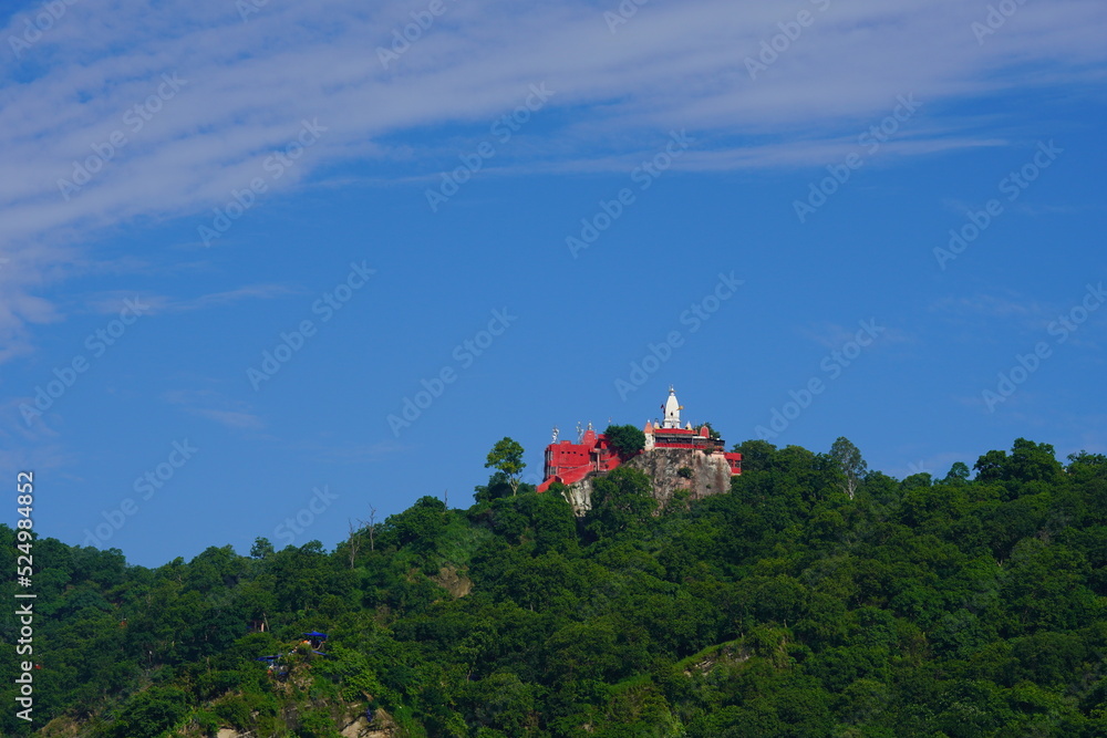 beautiful image of mansa devi temple on top of hill.
