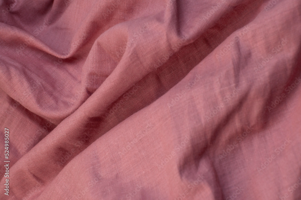 folds of purple curtains. wrinkled light fabric. pink creative background folds of purple curtains. wrinkled light fabric. pink creative background