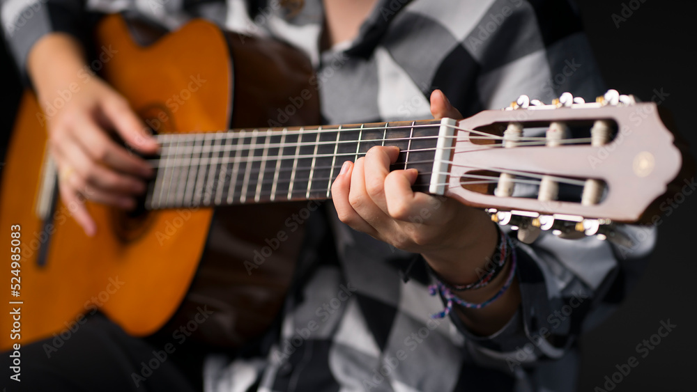 Girl playing the guitar. Image with selective focus