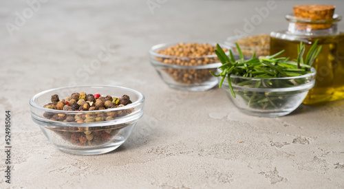 Various spices on the table, peppercorns in the foreground