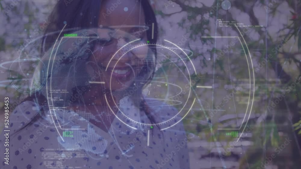 Animation of digital circles with data moving over happy young woman texting over smartphone in park Animation of digital circles with data moving over happy young woman texting over smartphone in park