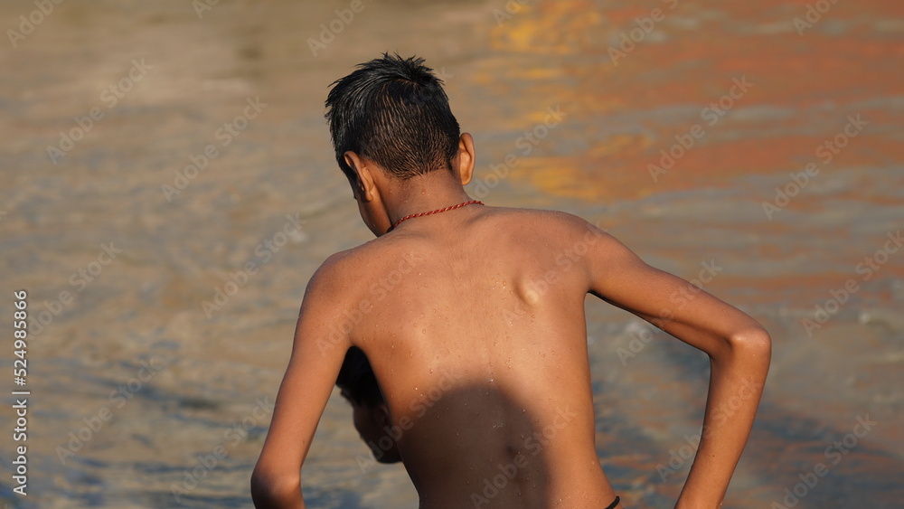 back picture of a boy inside the river. back picture of a boy inside the river.