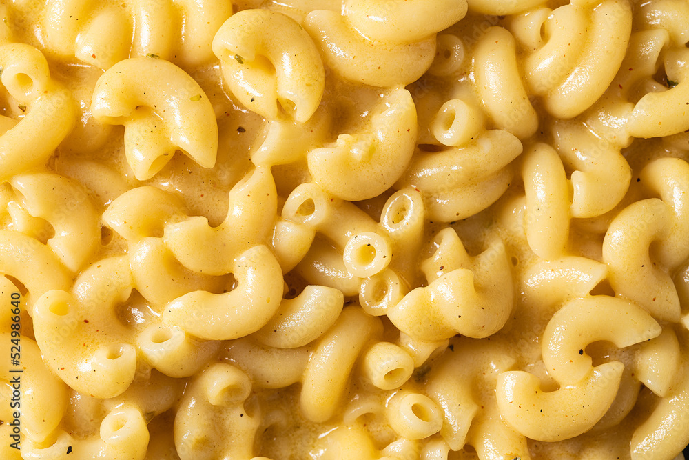 Delicious Mac n Cheese or macaroni and cheese on a black porcelain plate Delicious Mac n Cheese or macaroni and cheese on a black porcelain plate