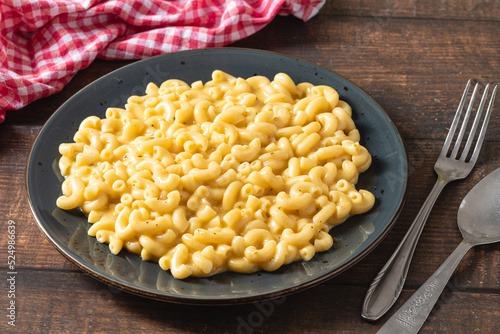Delicious Mac n Cheese or macaroni and cheese on a black porcelain plate photo