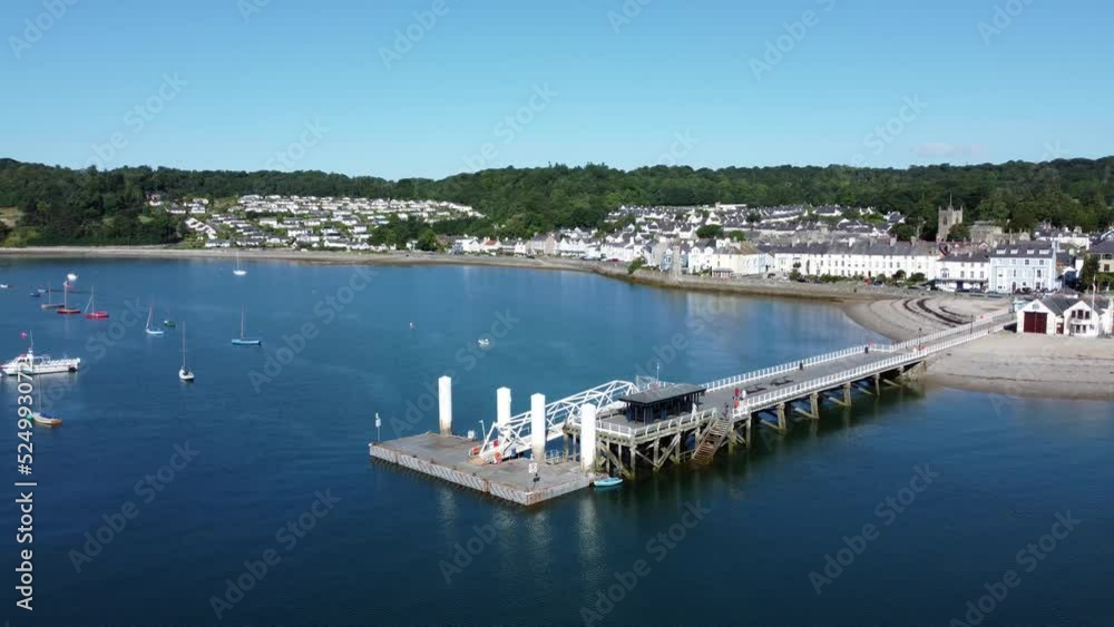 Beaumaris Pier aerial view orbiting Anglesey tourist attraction on peaceful warm coastal waterfront Beaumaris Pier aerial view orbiting Anglesey tourist attraction on peaceful warm coastal waterfront