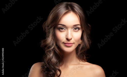 Close up portrait of Beautiful Long Hair Young Woman Looking at Camera. Captured in Studio on Black Background