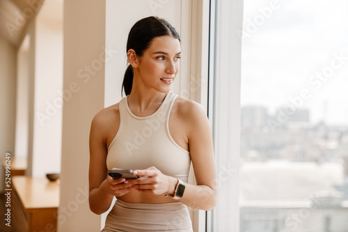 Young white woman using mobile phone during yoga practice Free Download Young white woman using mobile phone during yoga practice - GFXLoad