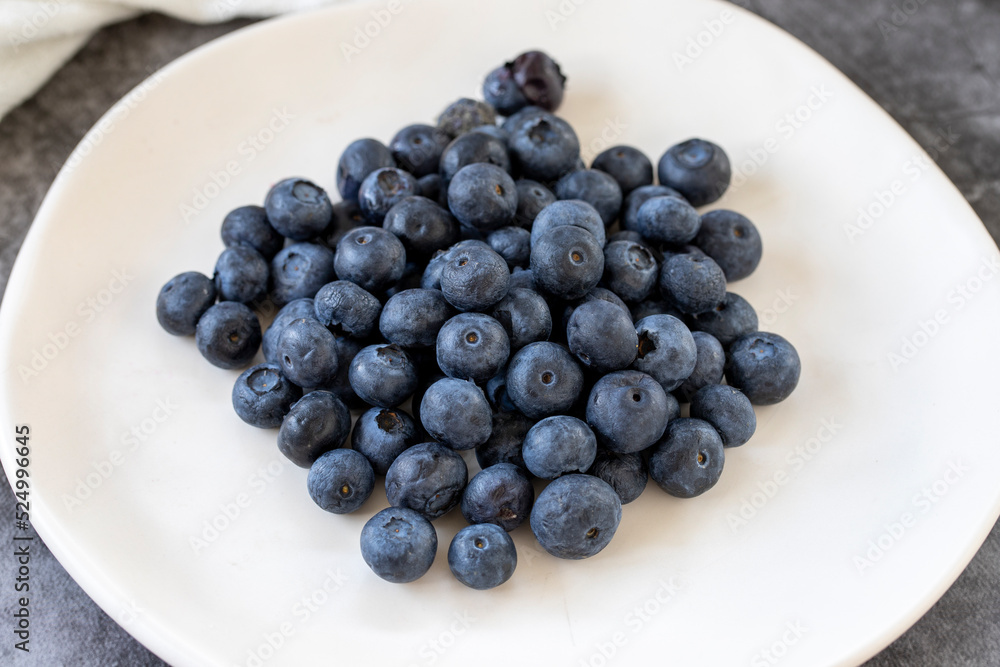 Blueberries on a dark background. Fresh blueberries on the plate. close up Blueberries on a dark background. Fresh blueberries on the plate. close up