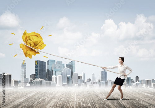 Obraz na płótnie Businesswoman pulling paper ball with rope and making it raise up w salonie
