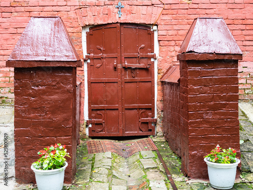 gate to basement of rural church Savior not made by hands in Muranovo village on rainy summer day photo