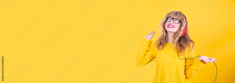 happy mature woman dancing with headphones and copy space happy mature woman dancing with headphones and copy space