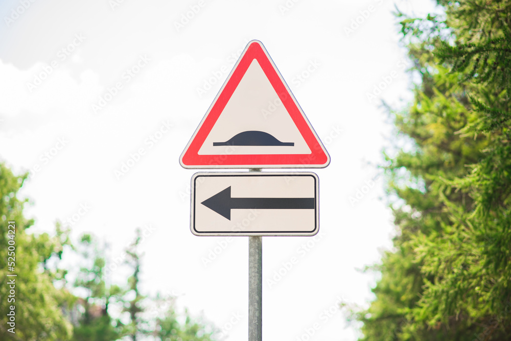 Road sign artificial irregularity and arrow. A barrier on the road. The concept of caution and warning.