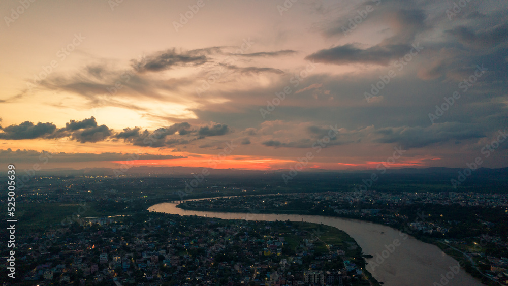 Aerial view of an Indian city with river during twilight