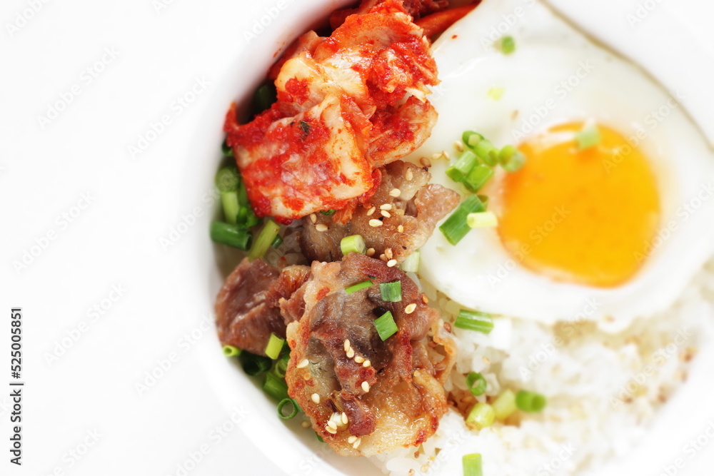 Korean food, barbecue beef and kimchi with sunny side up fried egg on rice for comfort food image Korean food, barbecue beef and kimchi with sunny side up fried egg on rice for comfort food image