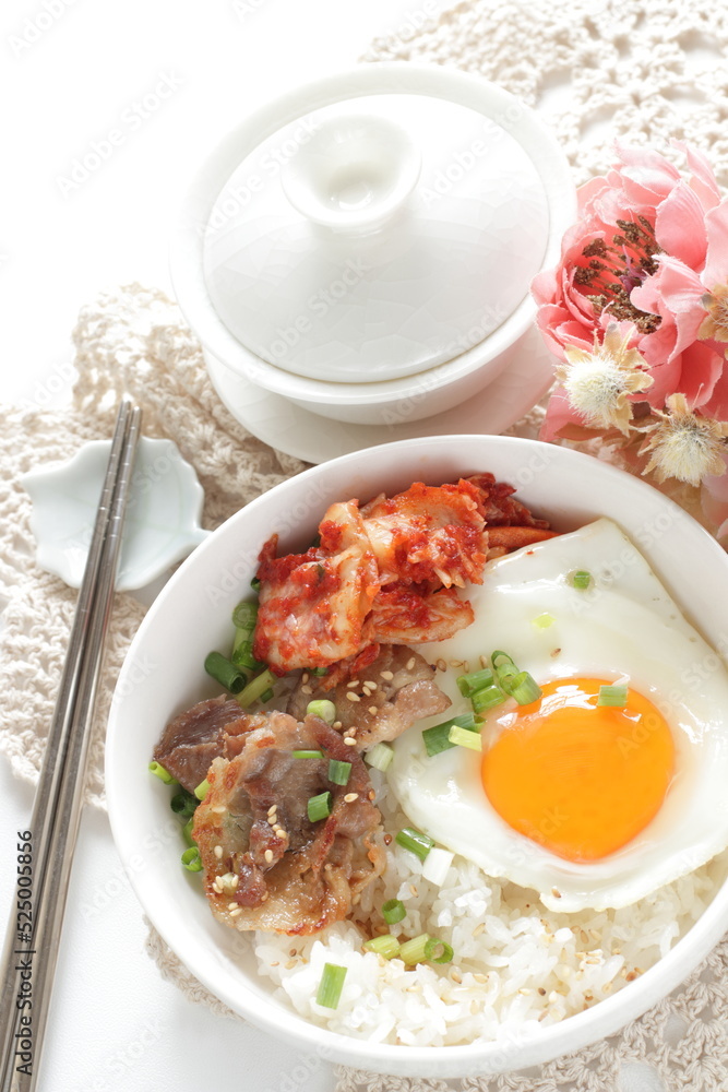 Korean food, barbecue beef and kimchi with sunny side up fried egg on rice for comfort food image Korean food, barbecue beef and kimchi with sunny side up fried egg on rice for comfort food image