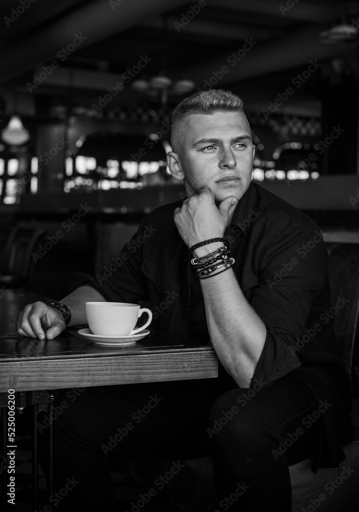 Young stylish Nordic blonde guy, portrait of modern youth. Confident boy with stylish clothes and accessories