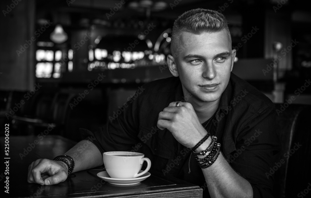 Young stylish Nordic blonde guy, portrait of modern youth. Confident boy with stylish clothes and accessories