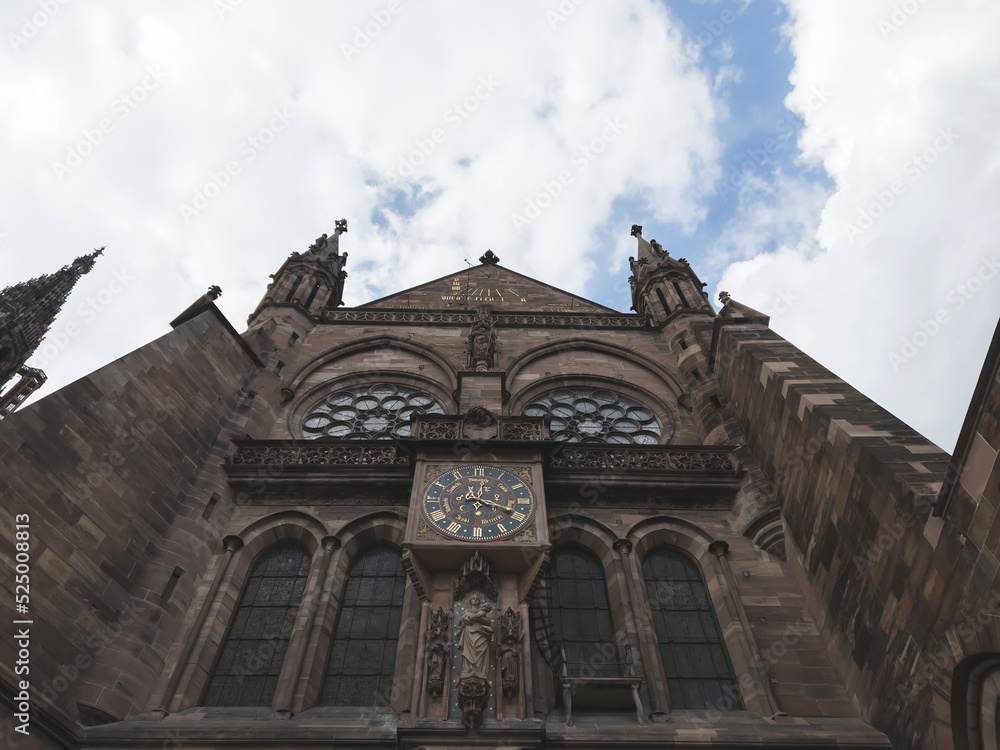 Wide low angle view of sloar clock calendar on the Strasbourg Cathedral or the Cathedral of Our Lady of Strasbourg, also known as Strasbourg Minster, is a Catholic cathedral in Strasbourg, Alsace Wide low angle view of sloar clock calendar on the Strasbourg Cathedral or the Cathedral of Our Lady of Strasbourg, also known as Strasbourg Minster, is a Catholic cathedral in Strasbourg, Alsace