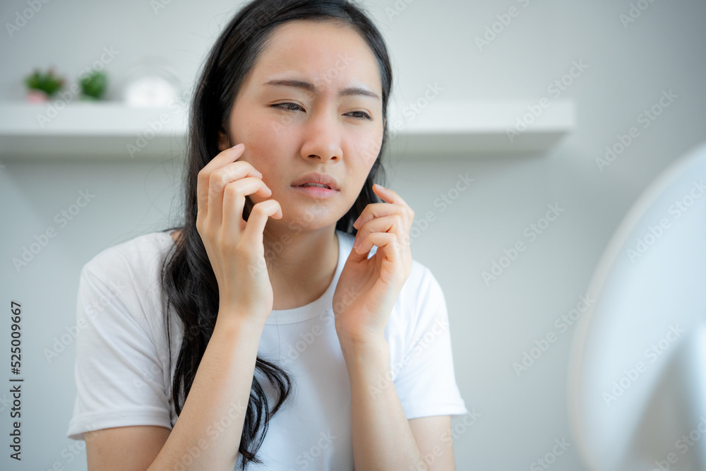 Woman asian worried about faces Dermatology, rosacea dermatitis, allergic steroids in cosmetics. sensitive skin, red face from sunburn, acne, allergic chemicals, rash on face, skin problem, beauty Woman asian worried about faces Dermatology, rosacea dermatitis, allergic steroids in cosmetics. sensitive skin, red face from sunburn, acne, allergic chemicals, rash on face, skin problem, beauty