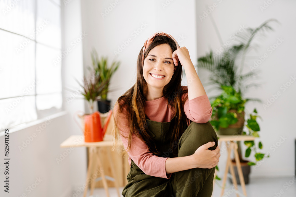 Smiling woman with long hair sitting at home Smiling woman with long hair sitting at home