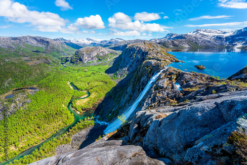 Norway, Nordland, Scenic view of lake Litlverivatnet and Litlverivassfossen waterfall photo