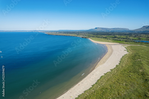 Stunning sandy beach and blue ocean and sky. Aerial view. Mullaghmore town area in county Sligo, Ireland, Popular travel destination with beautiful nature scenery and water sports. Warm sunny day. © mark_gusev