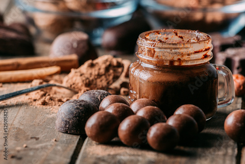 Tasty chocolate sweets and butter arranged on table with cocoa powder