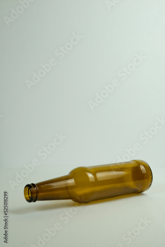 Empty bottle lying on a white background