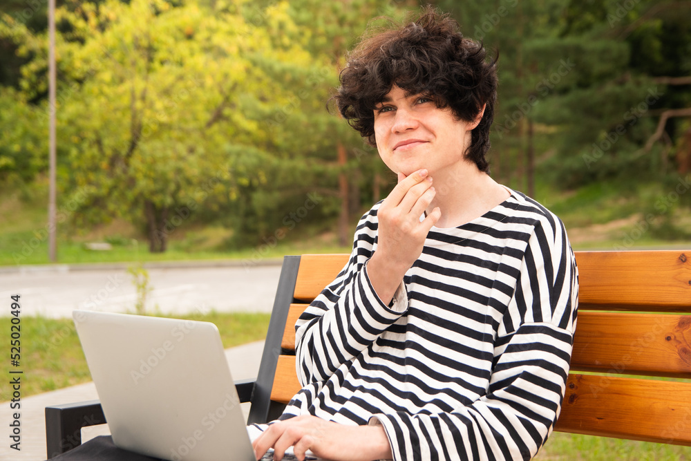 a young freelancer works in the park. work from anywhere in the world a young freelancer works in the park. work from anywhere in the world