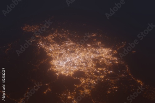 Aerial shot of Kuala Lumpur (Malaysia) at night, view from north. Imitation of satellite view on modern city with street lights and glow effect. 3d render