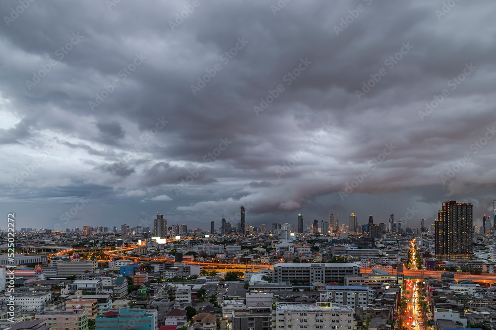 Fototapeta premium Modern city under dramatic stormy rainy clouds.