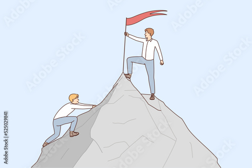Businessman put flag on mountain peak