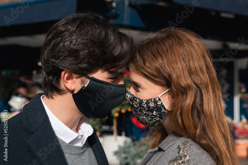 Romantic young couple in protective masks