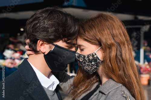 Romantic young couple in protective masks