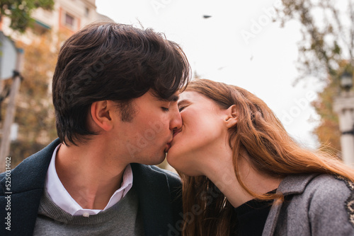 Young couple in love kissing on street