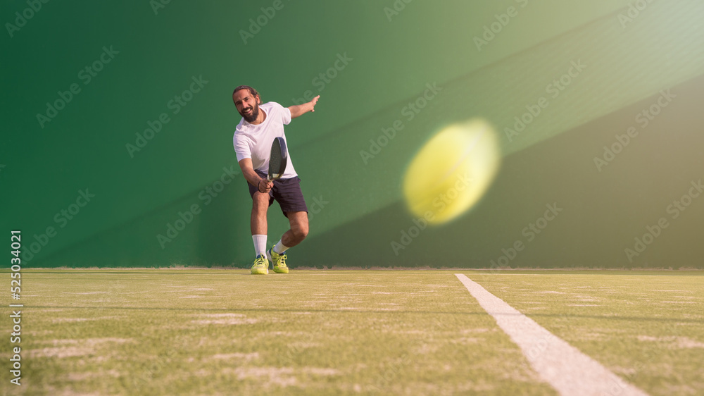 A caucasian padel player jump to the ball, good looking for posts and poster.