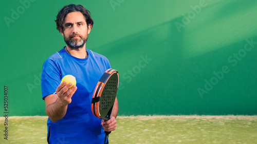 Monitor of padel holding black racket with yellow tennis ball in the hand. © REC Stock Footage