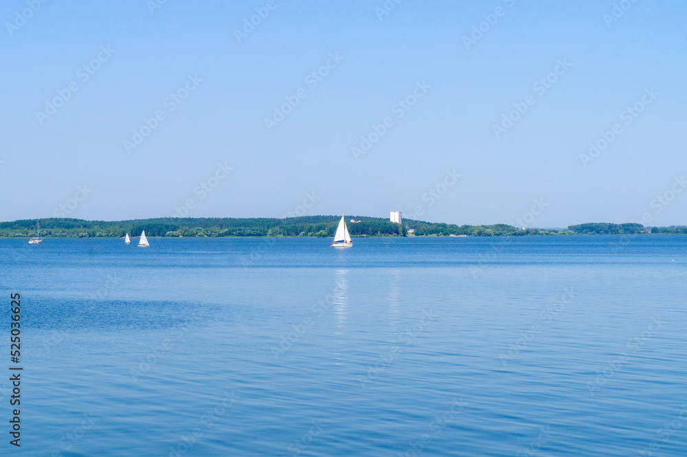 Seascape with white sails on the horizon. Summer natural background
