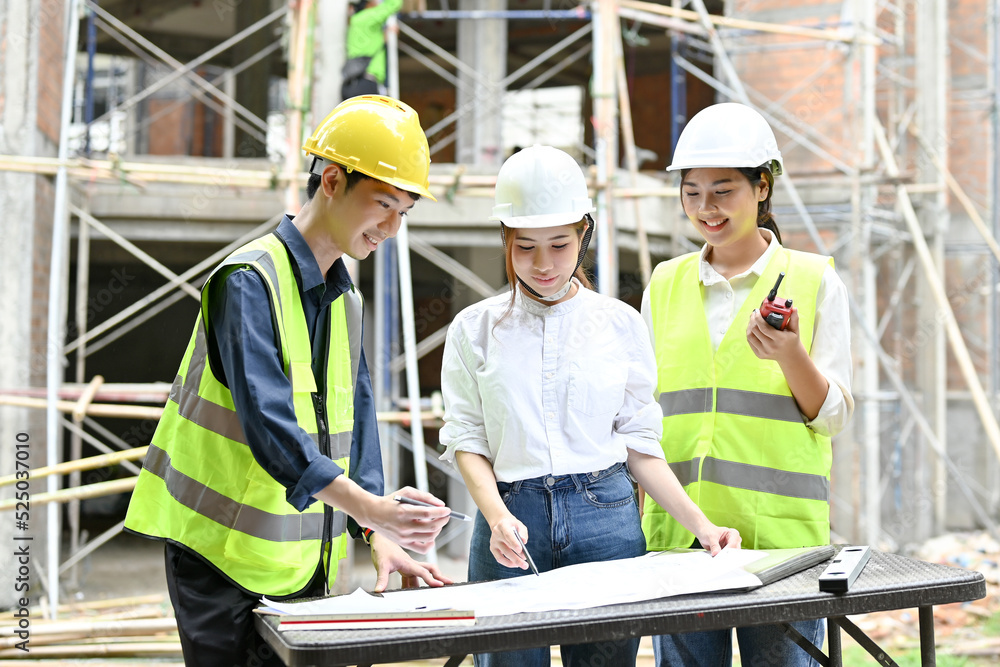 A team of civil engineers are working and inspecting the building together A team of civil engineers are working and inspecting the building together