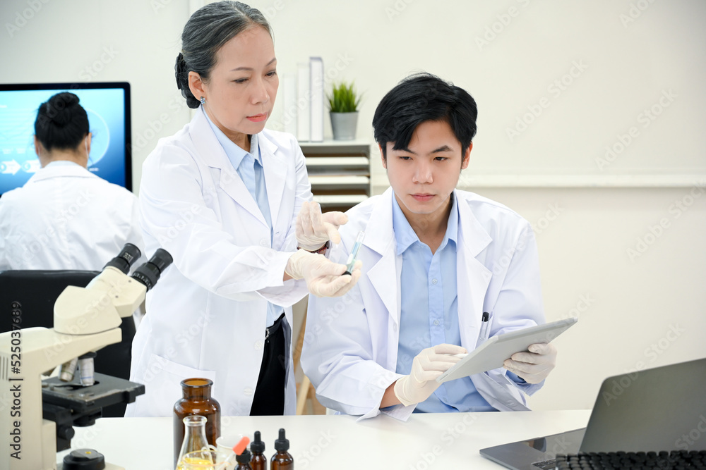 Two professional Asian scientists working together in the lab. Two professional Asian scientists working together in the lab.