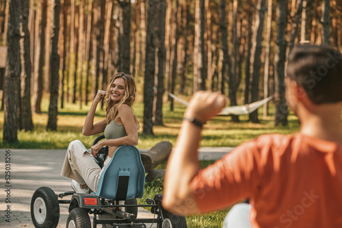 Young couple on quadrocycles looking happy and excited photo