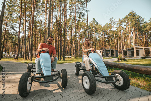 Young couple on quadrocycles looking happy and excited